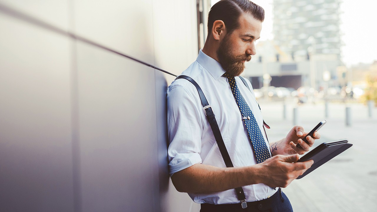 Man using smartphone and digital tablet